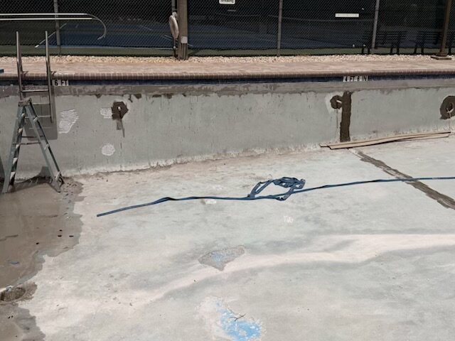 Empty West Pool prepared for resurfacing
